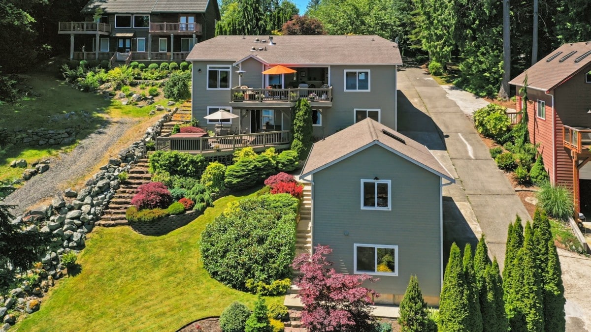 gray-houses-on-green-sloping-hill