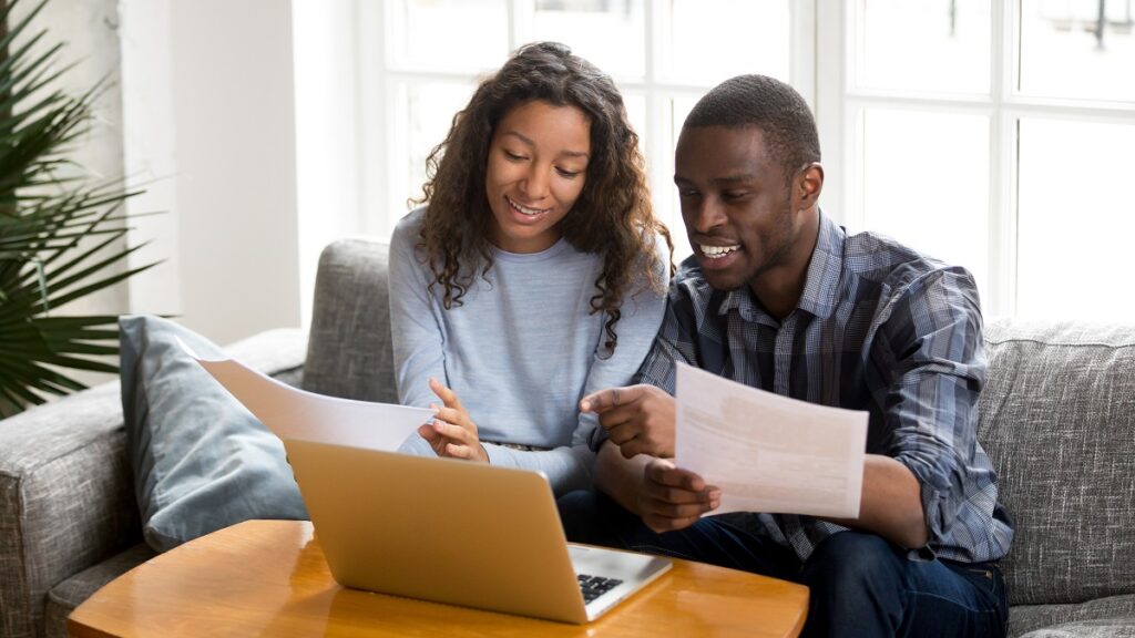 Couple on a computer prepares a spouse petition for a green card.