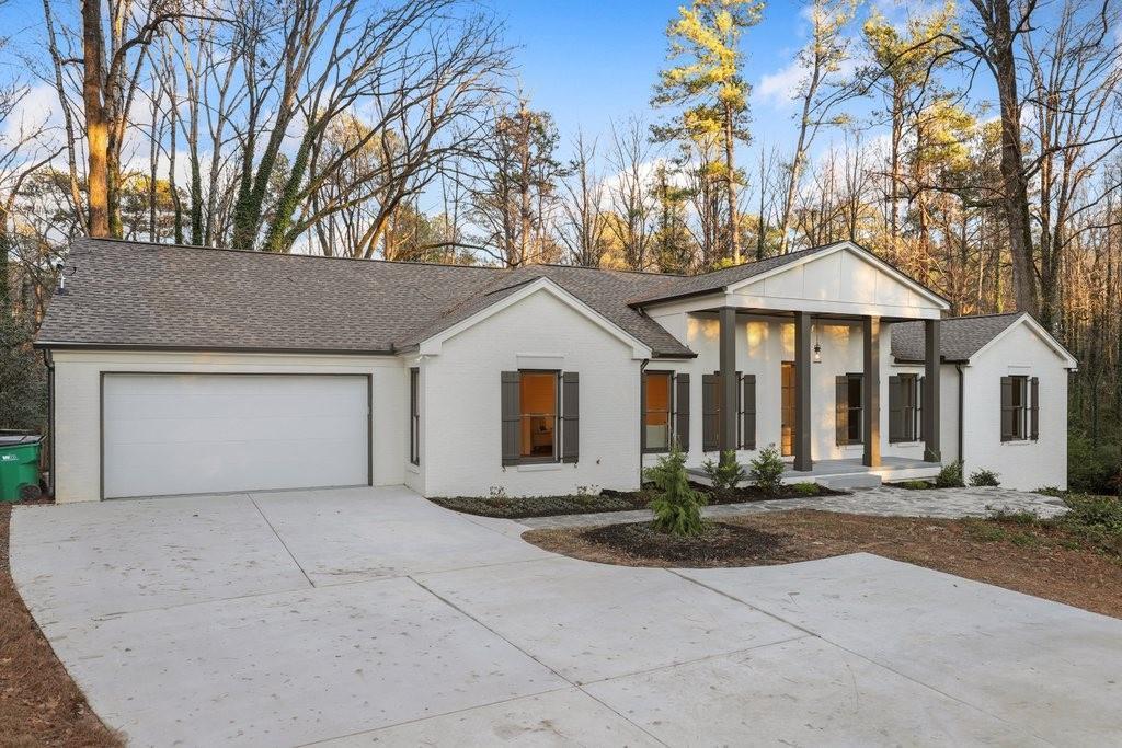 suburban ranch home with plain white exterior and a few columns