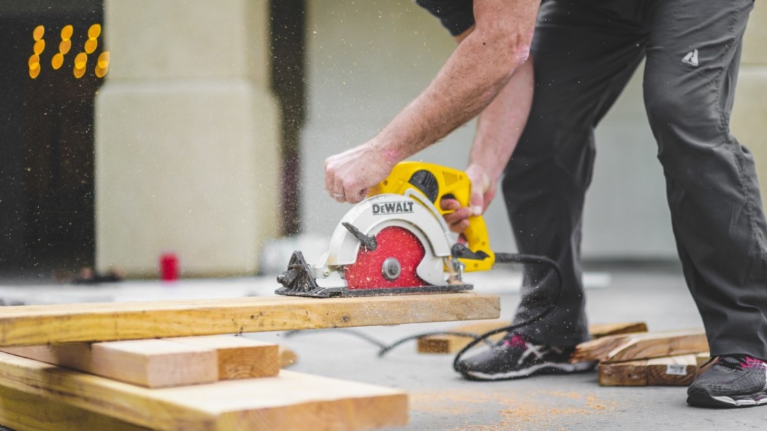 Contractor using a handsaw on wood