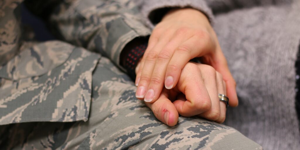 Fiancé of service member holds hands during immigration process